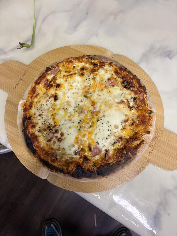 Pizza ingredients prepared beside Piezano